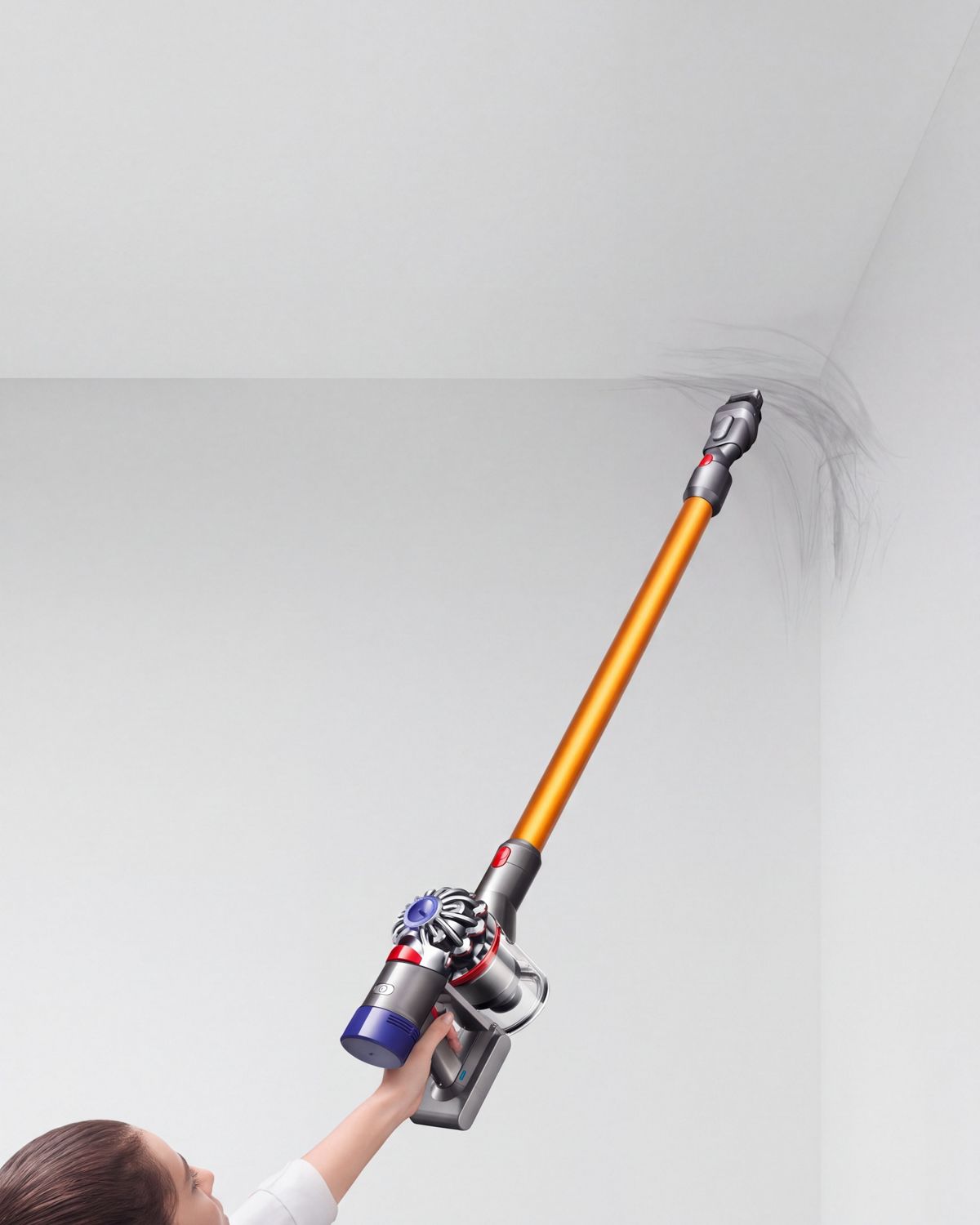 Dyson V8 Absolute cordless vacuum cleaner removing a cobweb from a hard to reach area. 