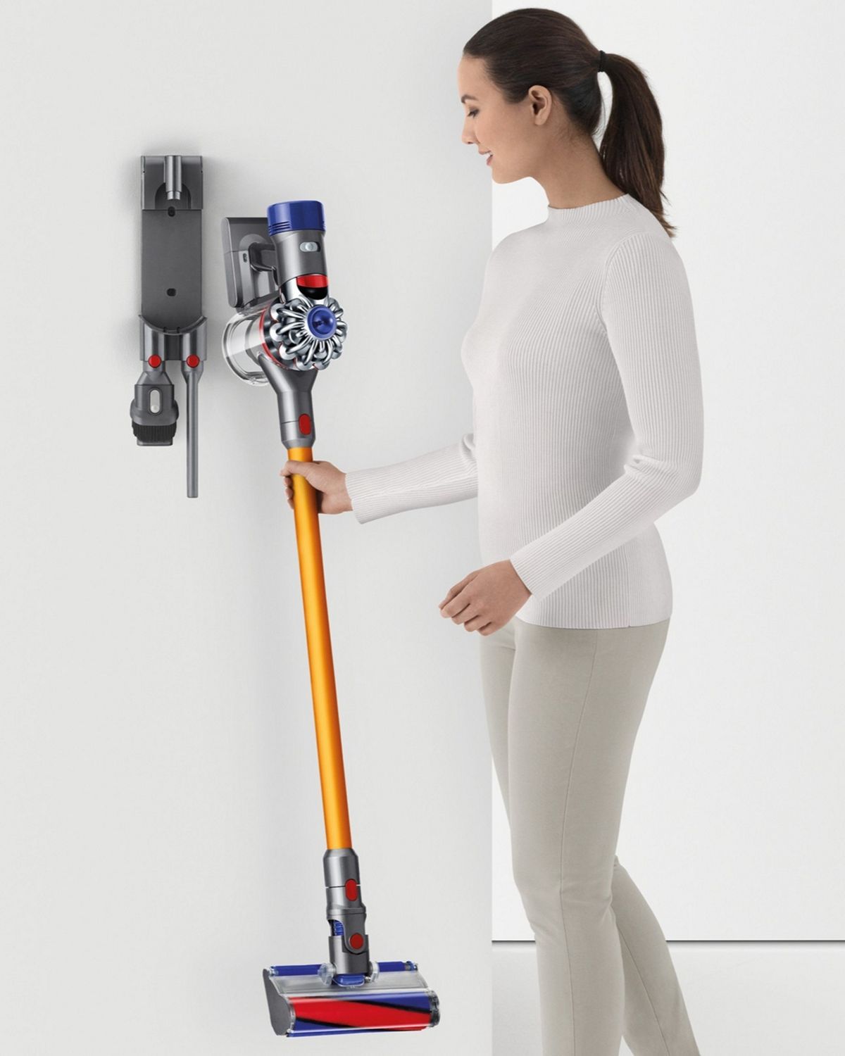 Dyson V8 Absolute cordless vacuum cleaner being placed into charging dock.