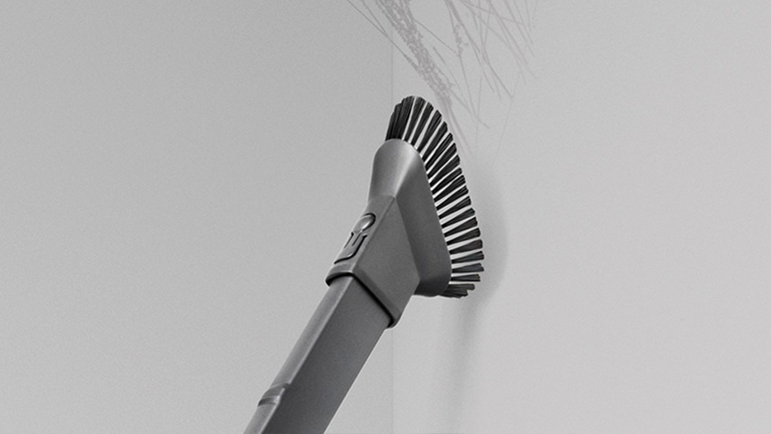 Dyson ball Animal 2 upright vacuum cleaner extendable hose being used to clean a high area.