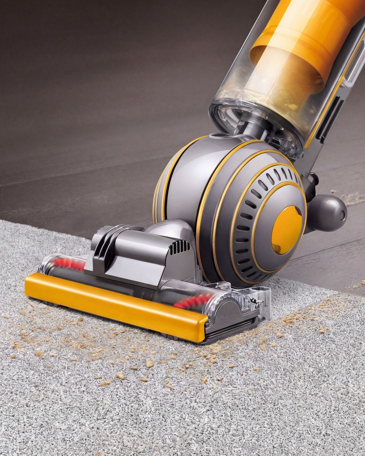 Dyson Ball Multifloor 2 upright vacuum cleaner picking up debris from carpet.