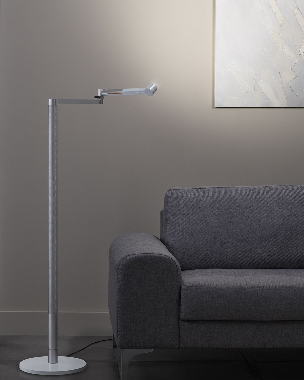 The Dyson Lightcycle Morph light set to face the wall, illuminating a painting and creating indirect light in the room. 