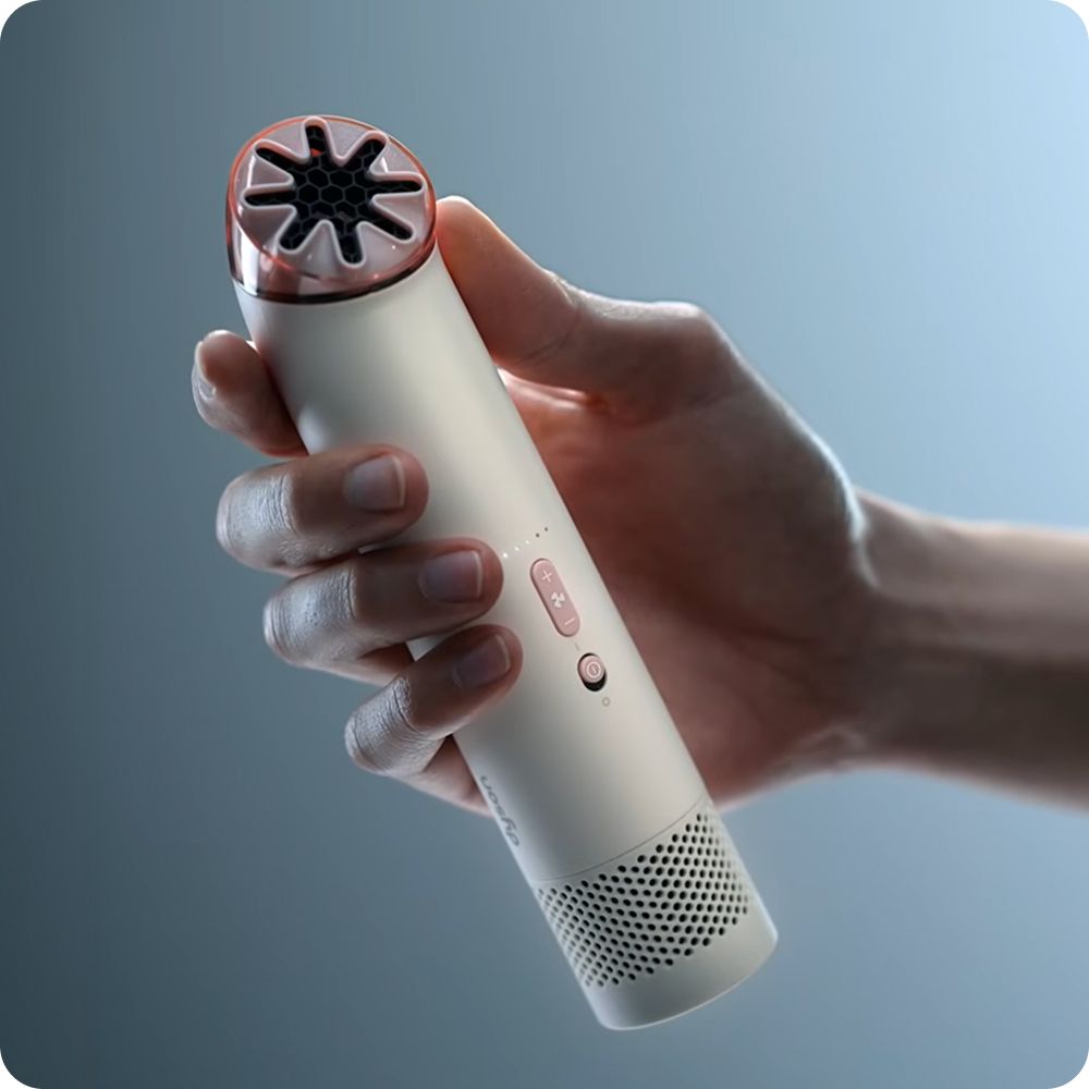 Dyson HushJet Mini Cool fan held in a hand.