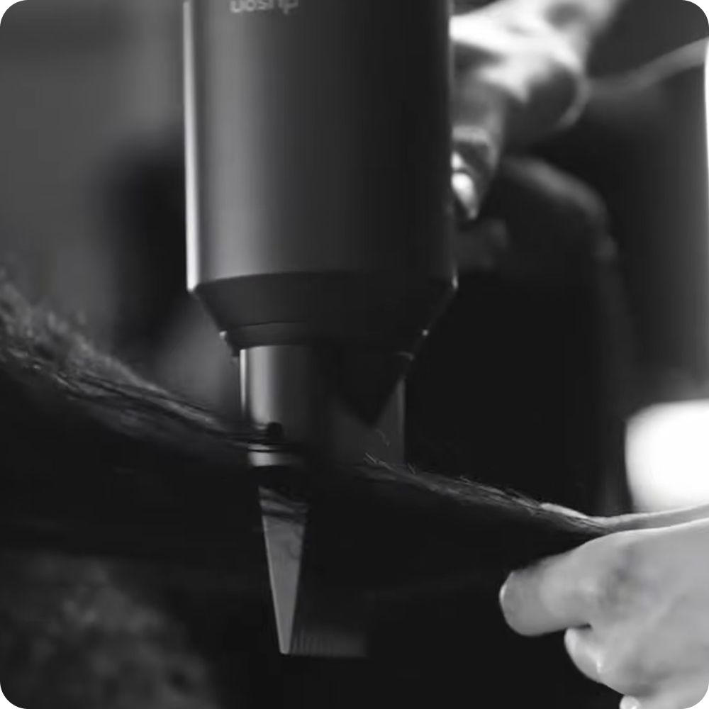 Hair is stretched while drying using an attachment for the Dyson Supersonic hair dryer.