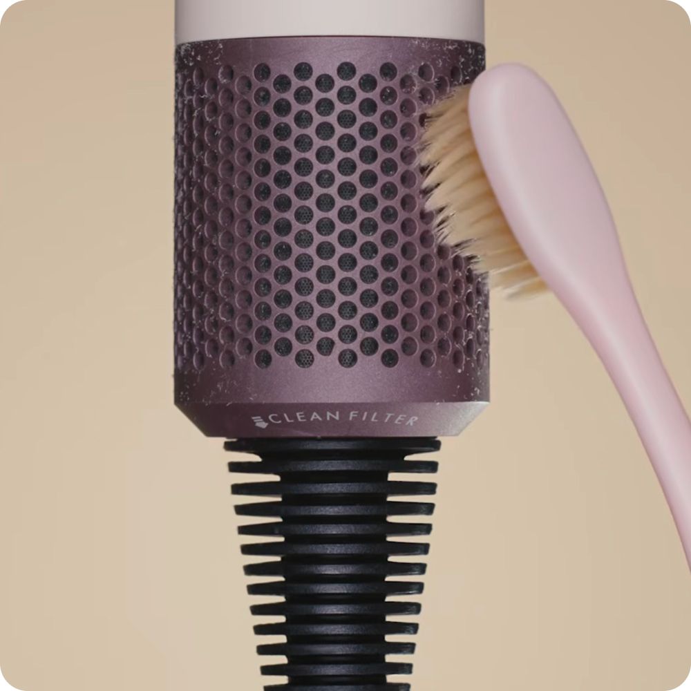 The filter of the Dyson Supersonic Travel hair dryer is cleaned.