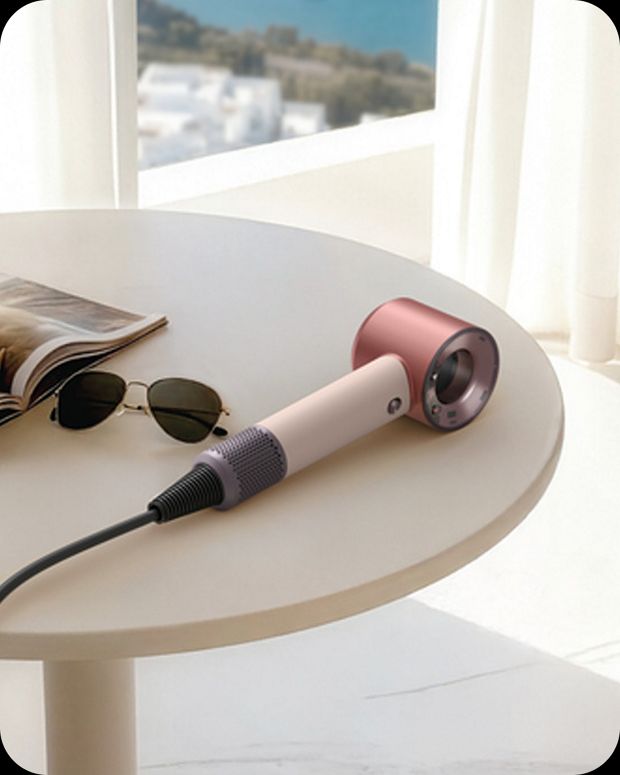Dyson Supersonic Travel hair dryer on a table.