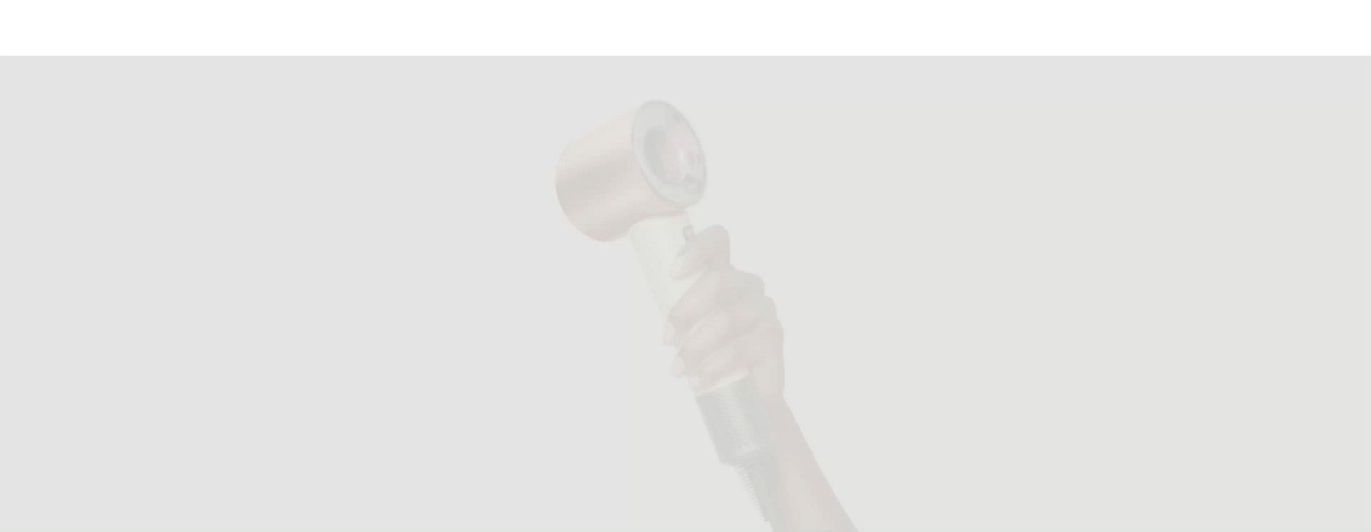 A Dyson Supersonic Travel hair dryer held in a hand.