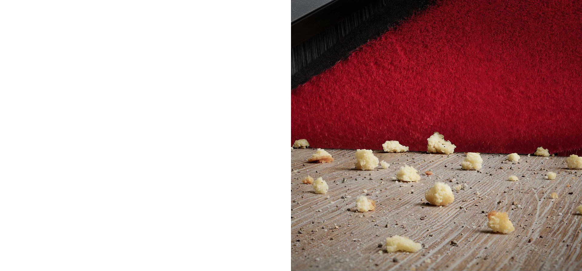 Close-up of Dyson 360 Vis Nav's stiff nylon bristles removing dust from a deep pile carpet