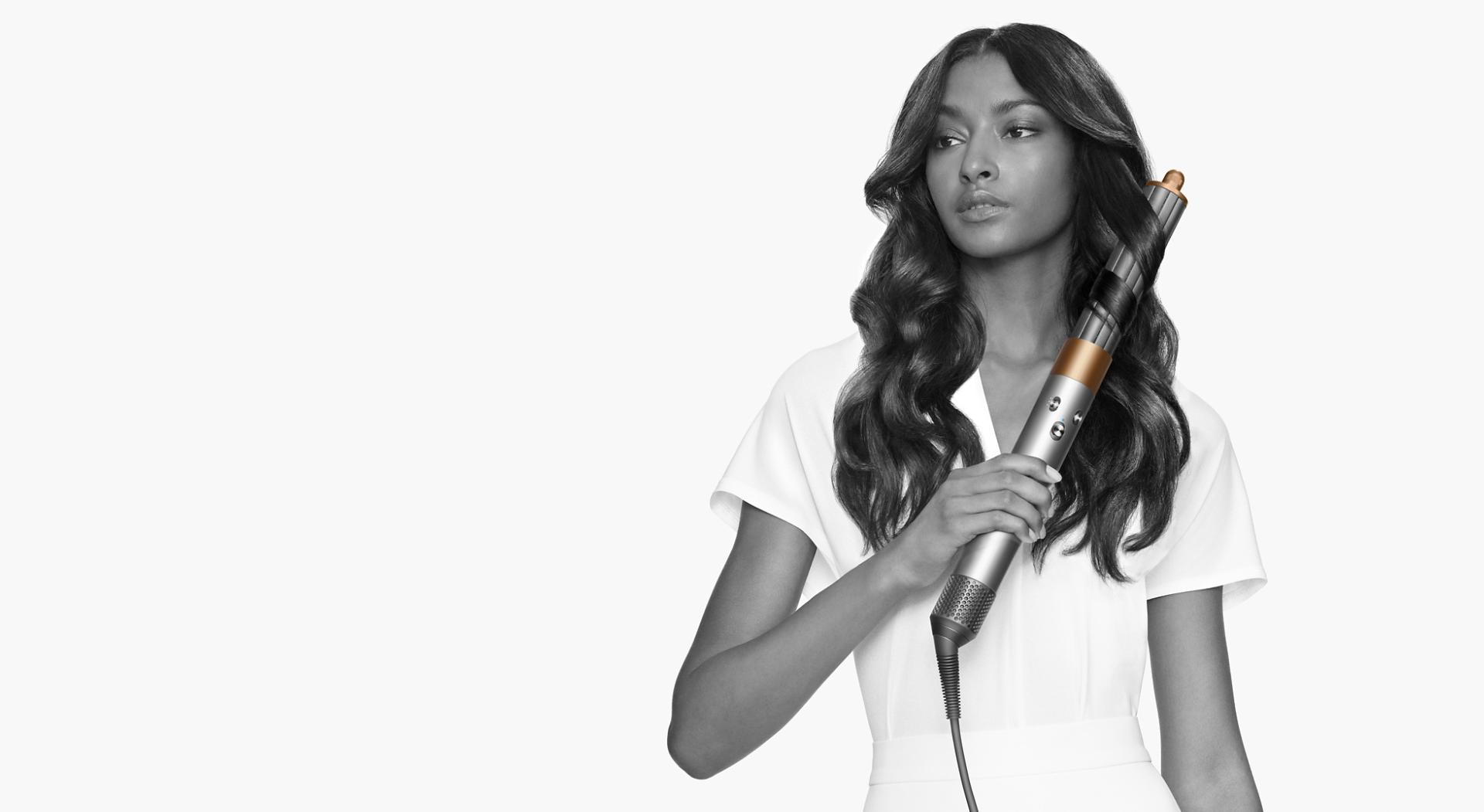 Model curls her hair with Dyson Airwrap multi-styler