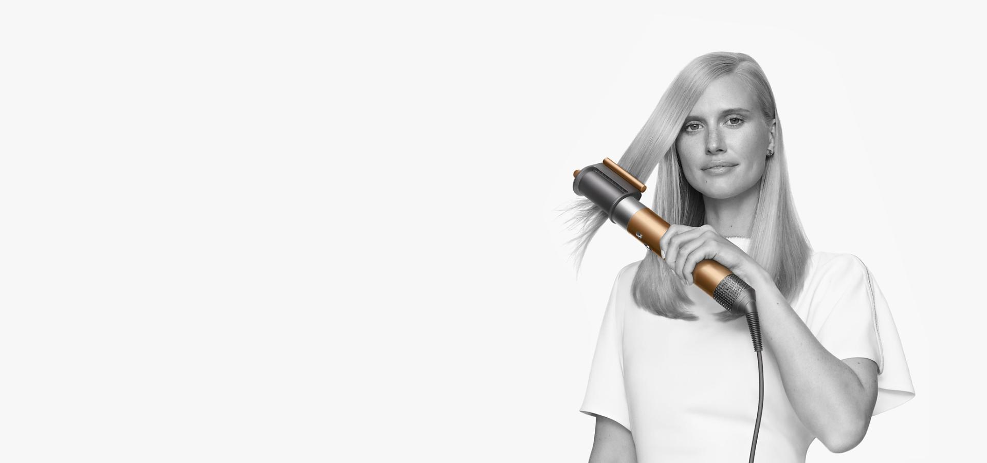 Model using Dyson Airwrap with brush attachment