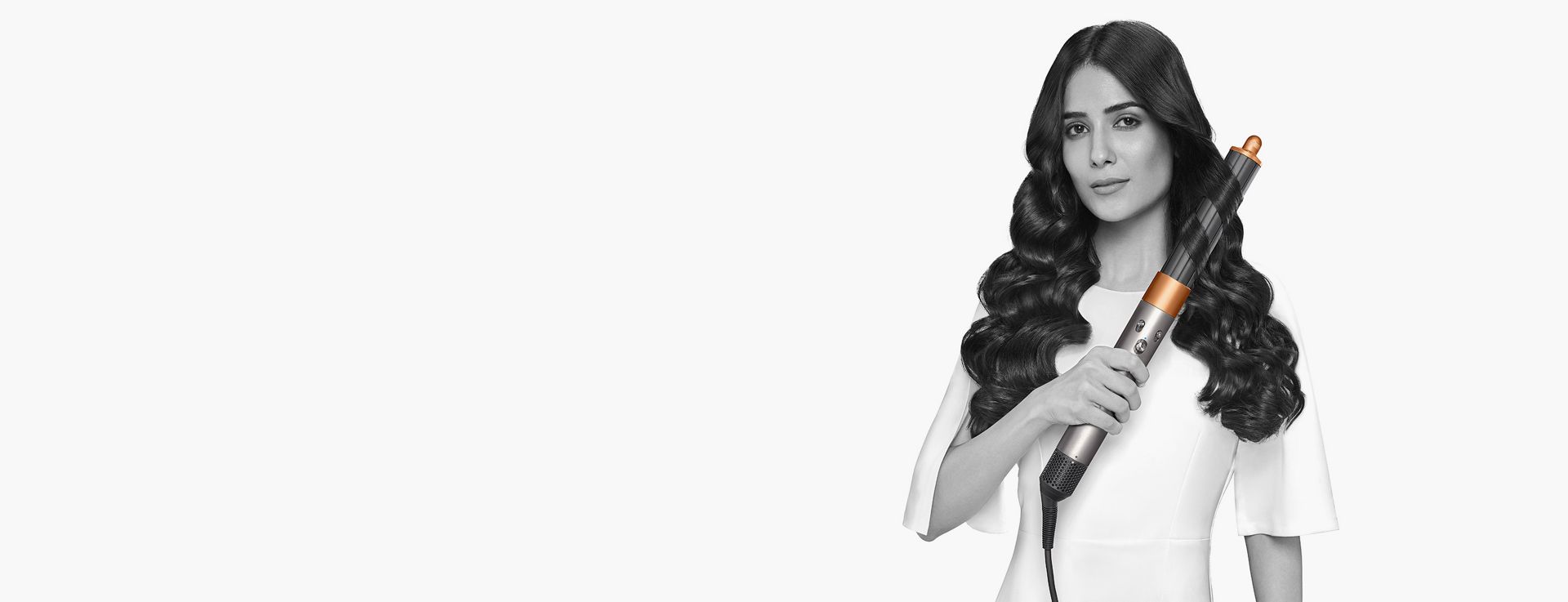 Dyson Airwrap Origin multi-styler and dryer used by a model to style her hair.