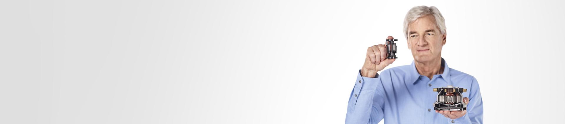 James Dyson holding Dyson digital motor V10