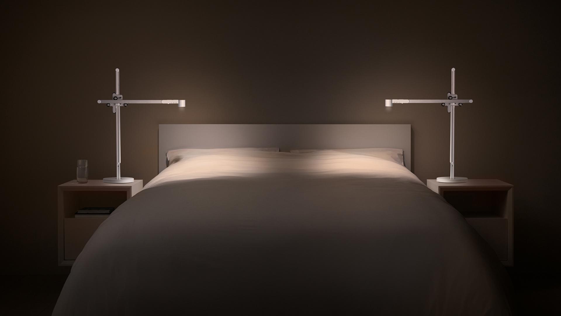 Two Dyson Lightcycle™ task lights on either side of a bed in perfect symmetry