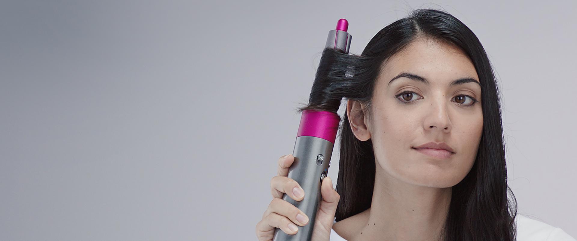 Three models using different Dyson Airwrap™ hair styler  attachments 