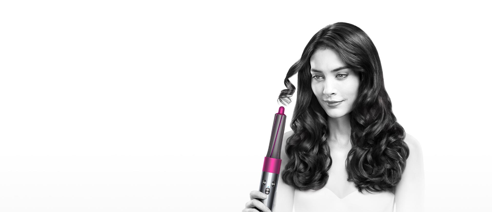 Model demonstrating the Dyson Airwrap™ hair styler to create bouncy curls