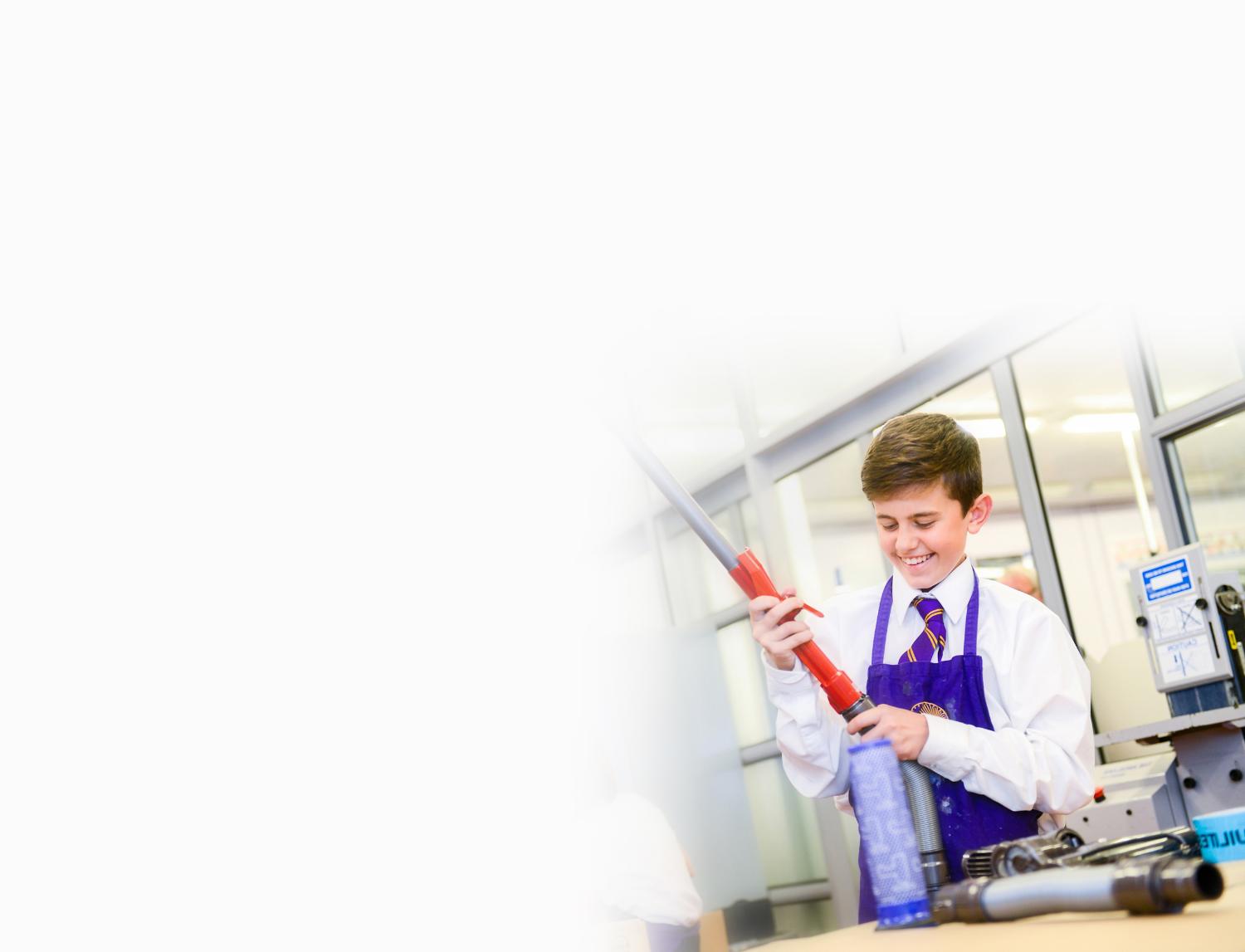 Schoolboy with vacuum cleaner