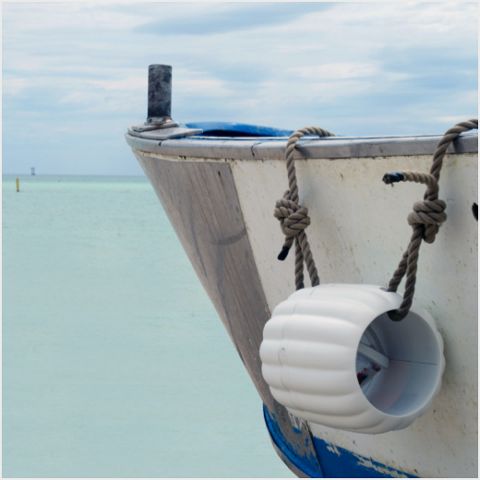 Boat out at sea with the Cloud of sea device hanging over the edge.