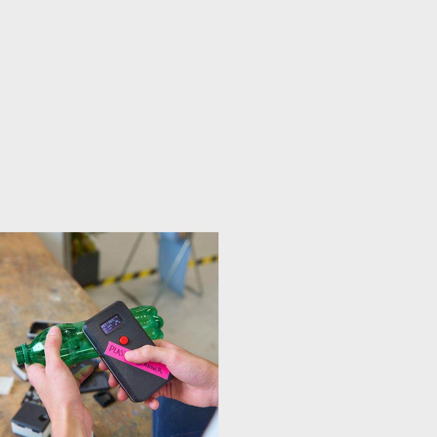 Pair of hands using the Plastic Scanner technology on a green plastic bottle. 