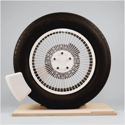 A tyre with grey background displayed on a tile.