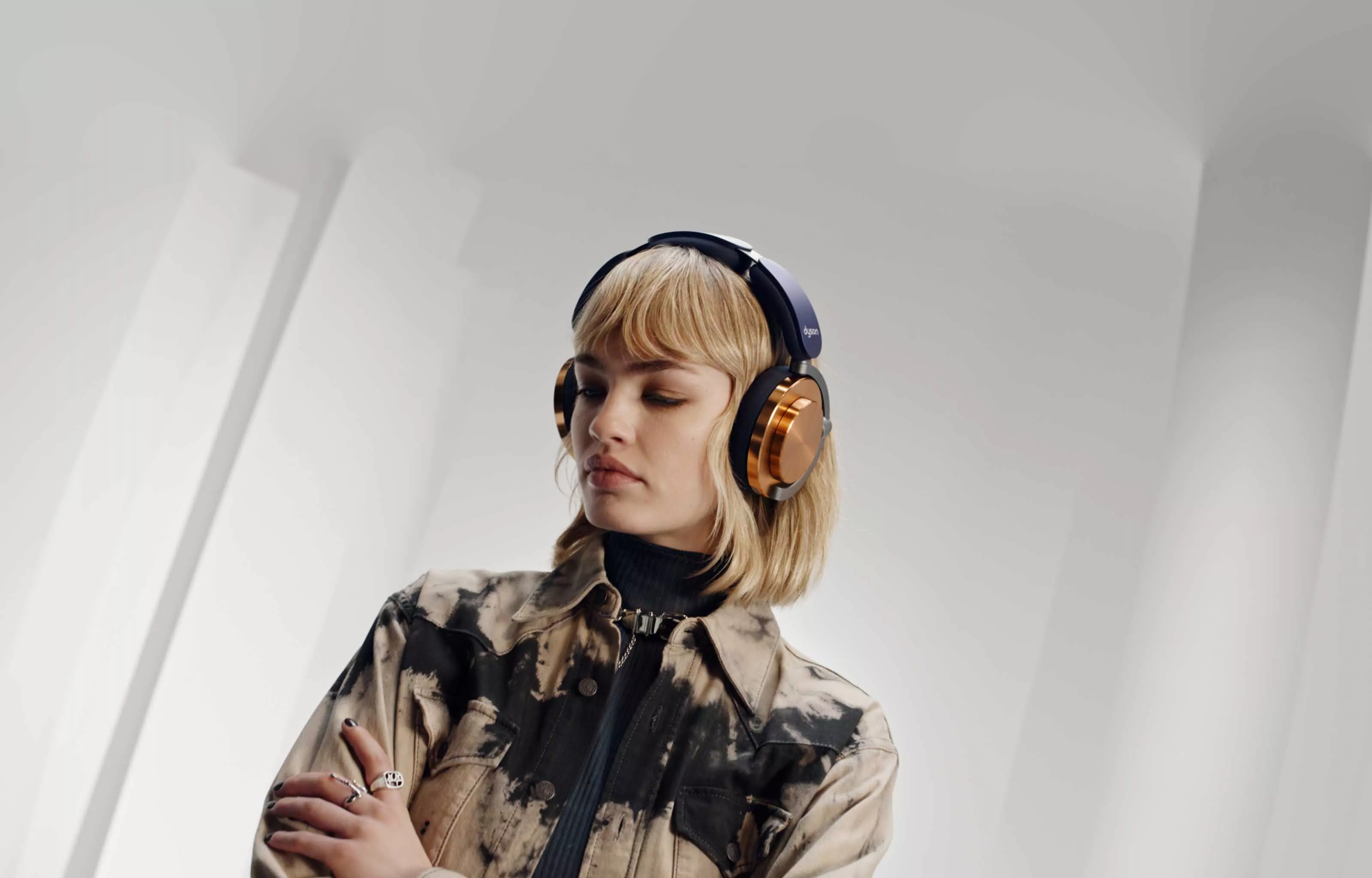 A woman wearing Dyson Ontrac headphones