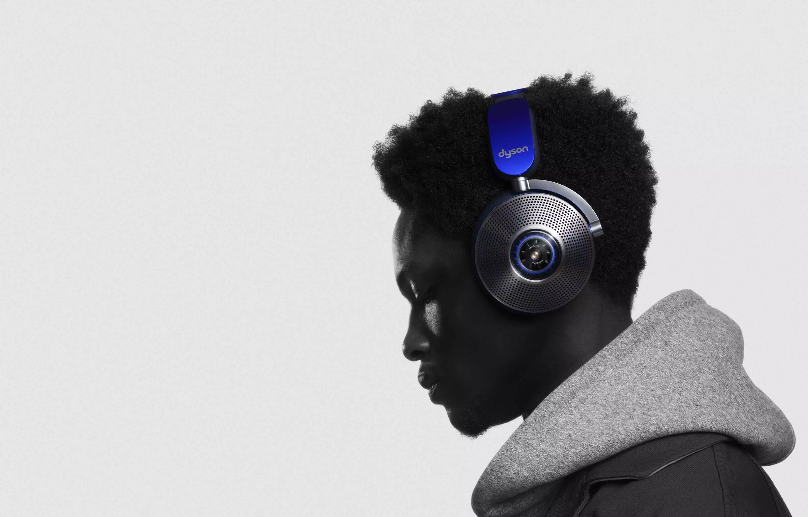 Side view of man wearing Dyson zone noise-cancelling headphones.