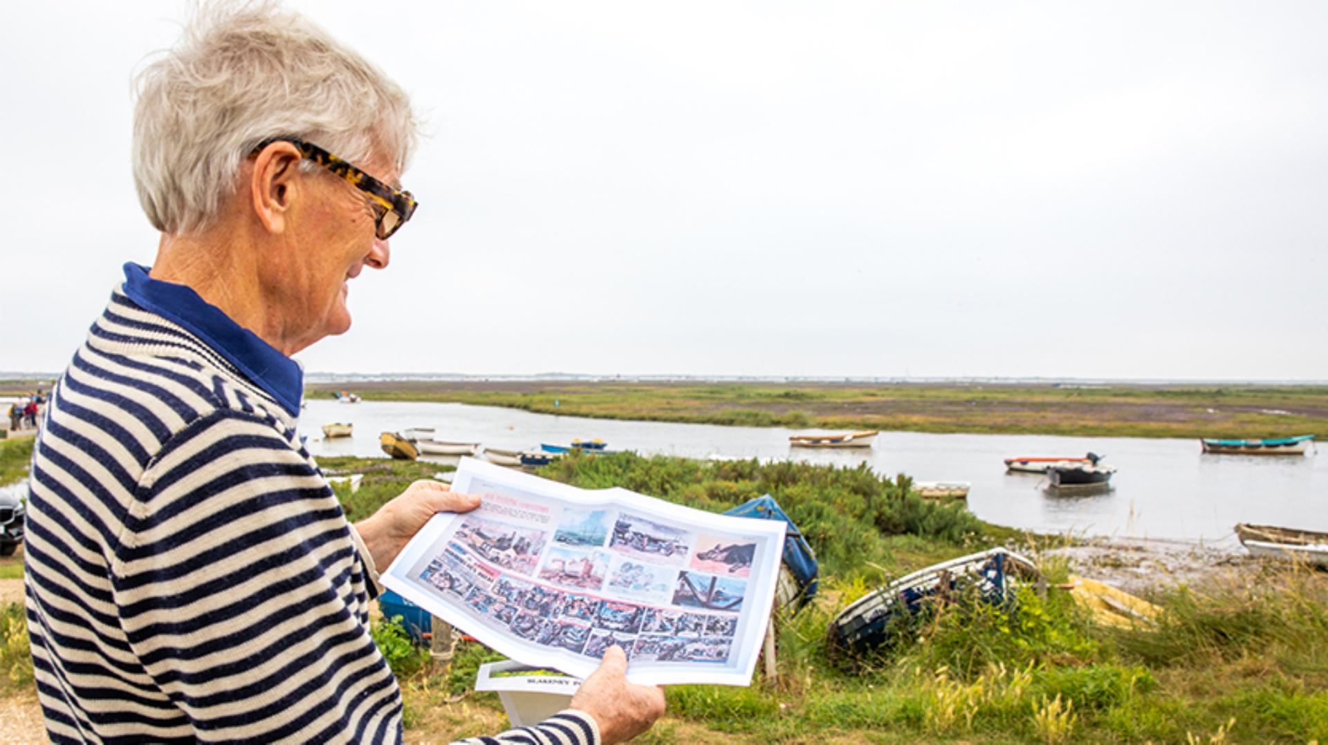 James Dyson holding a copy of the 1957 Eagle a