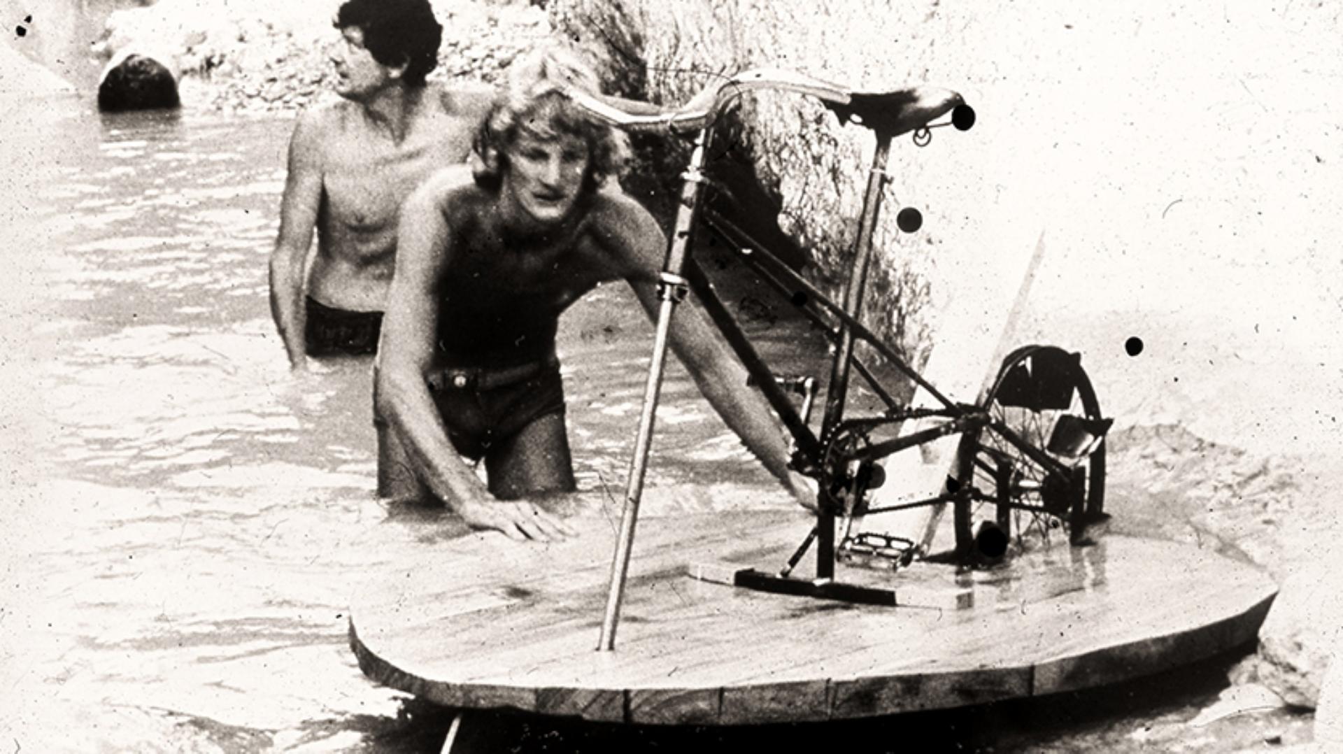 James Dyson pushing the prototype pedalo through the water