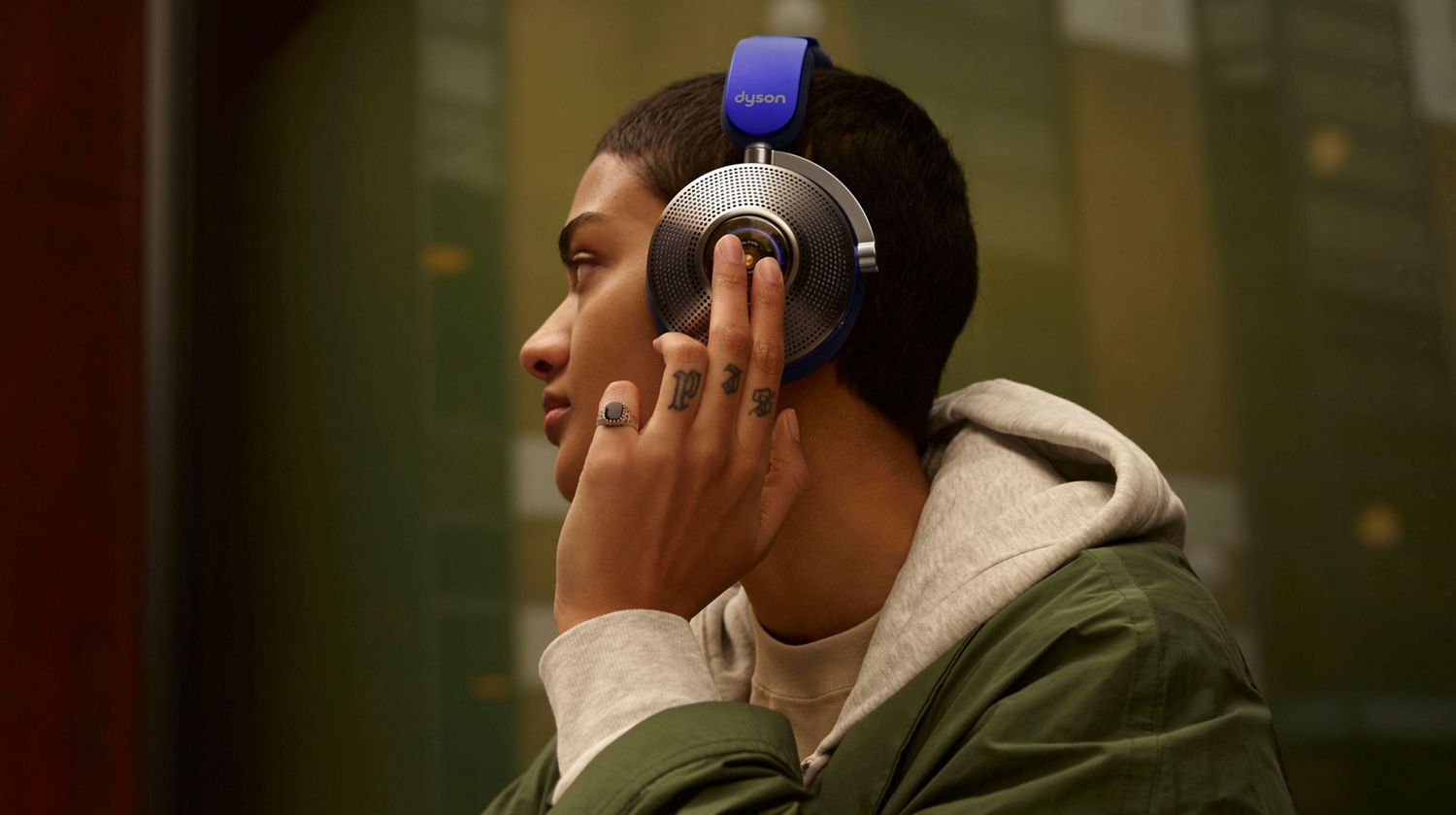 Model wearing the Dyson Zone noise-cancelling headphones.