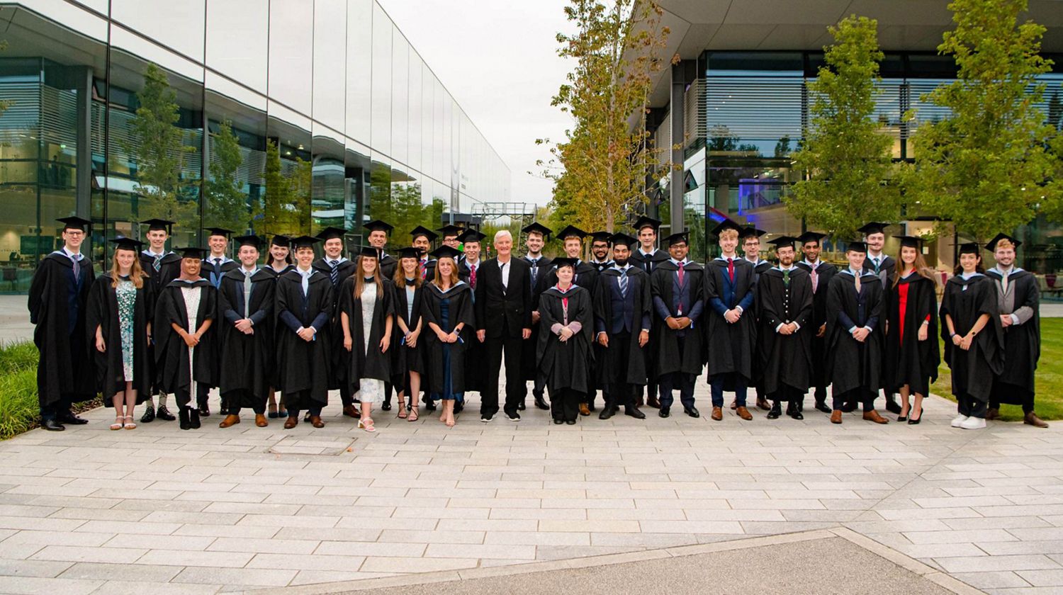 James and a cohort of students on graduation day.