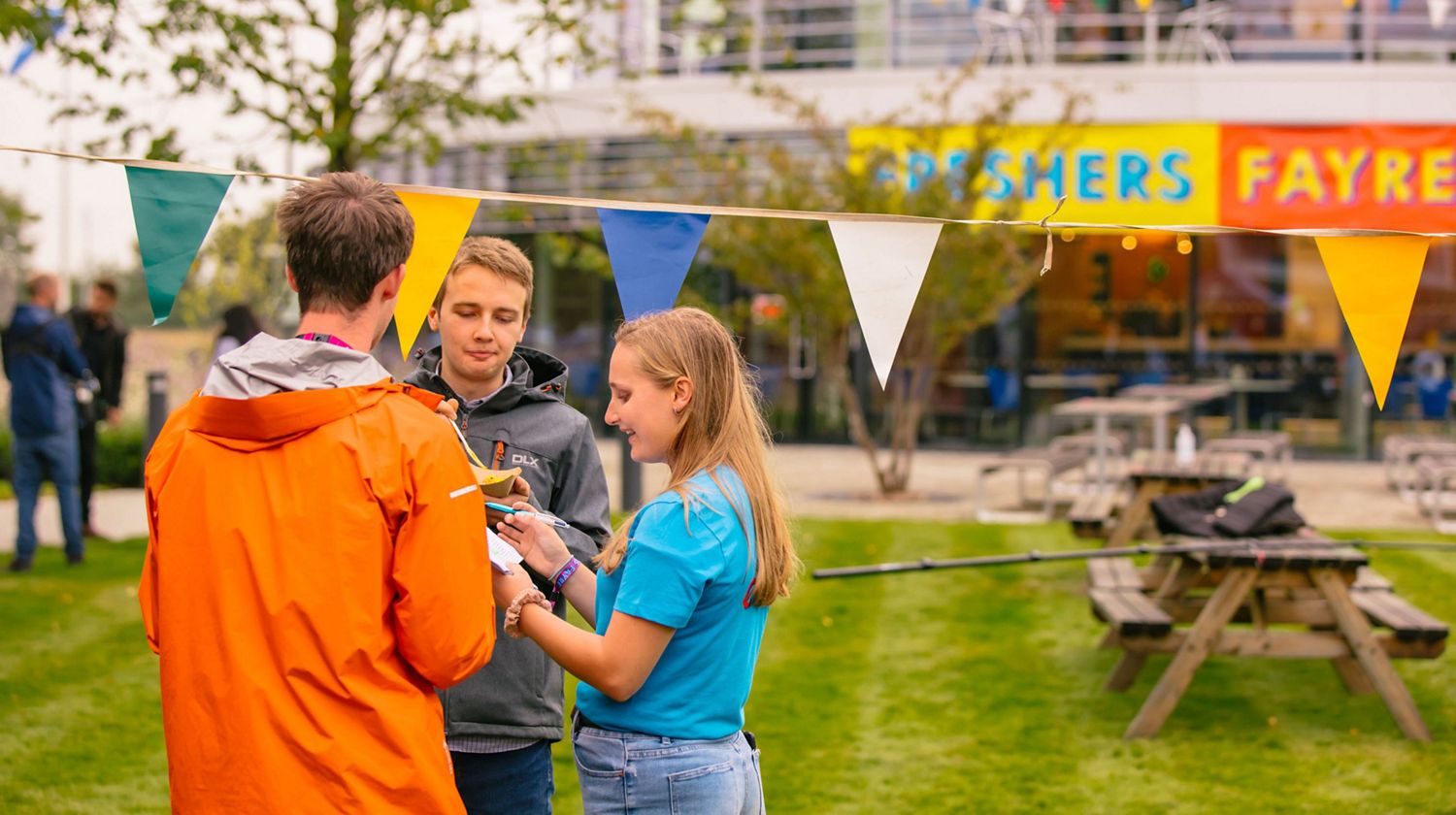 Students talking at the Fresher's Fayre at the institute.
