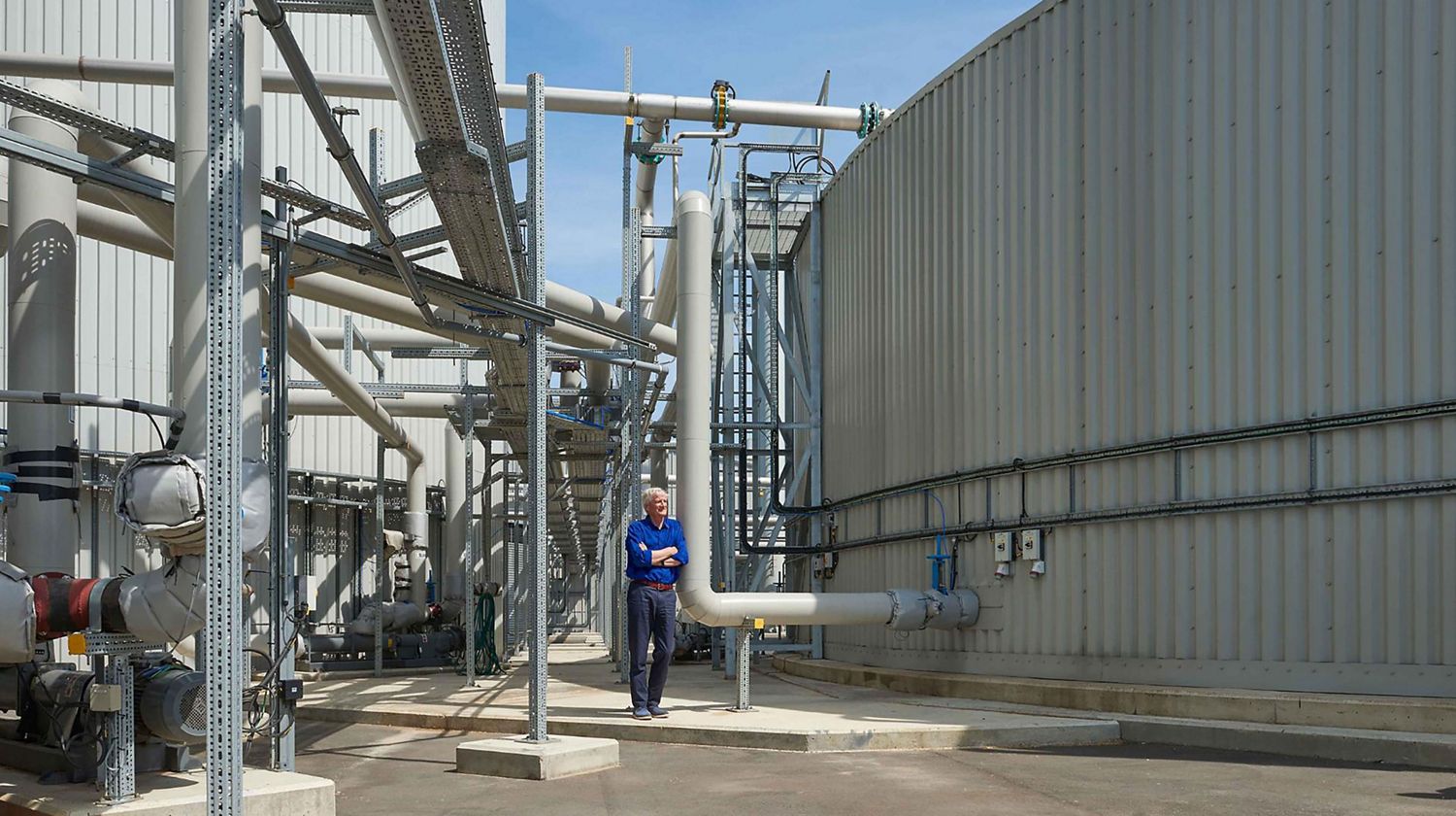 James Dyson standing next to an anaerobic digester.