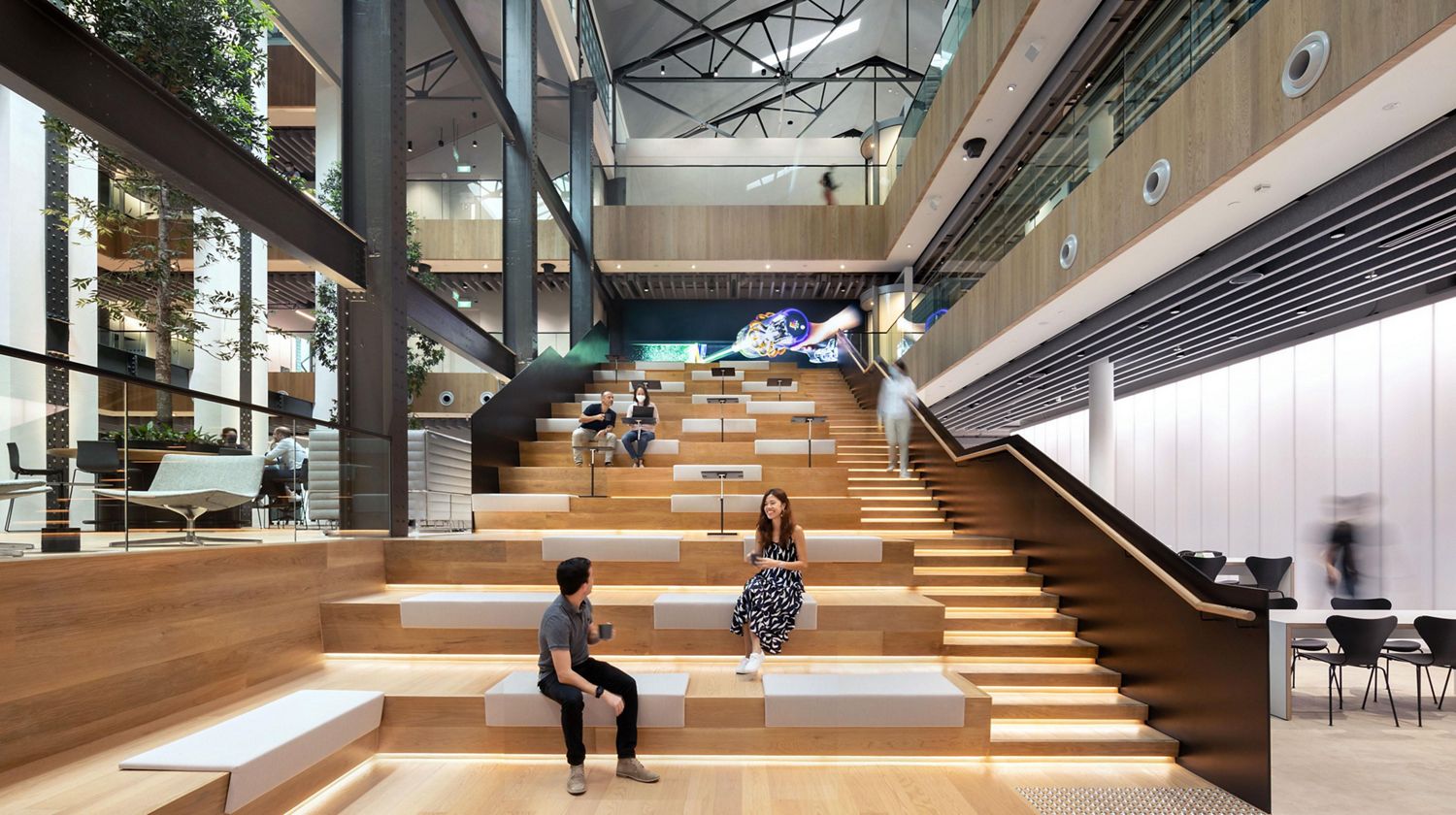 Workers talking on stairs at St James' Power Station.