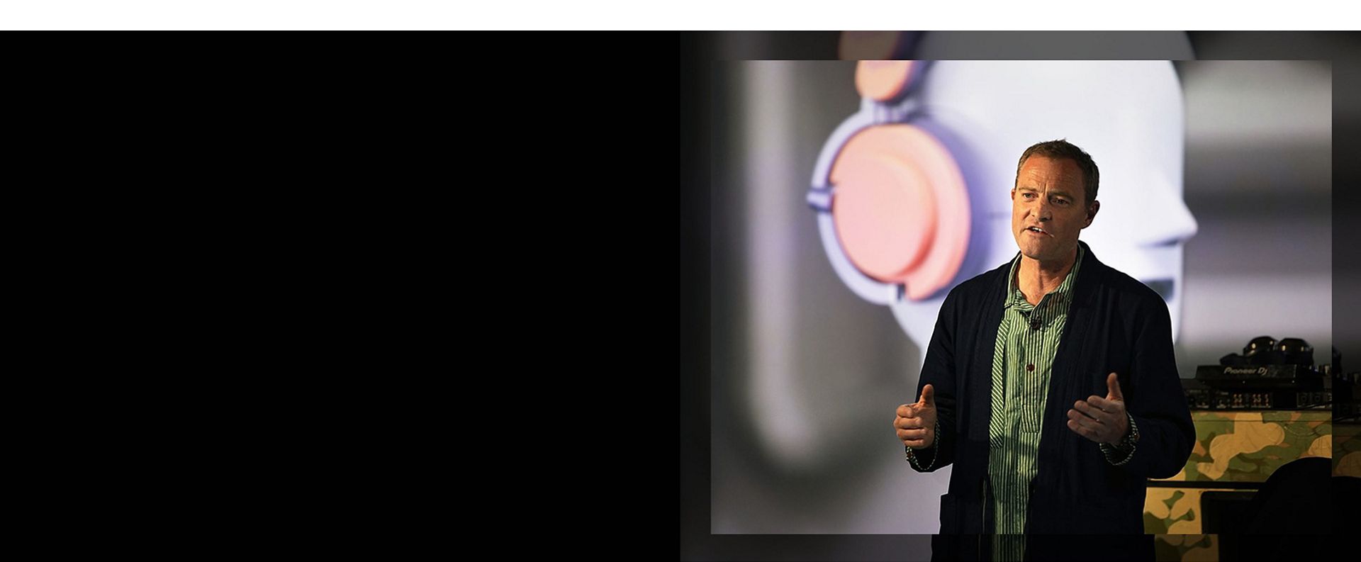 Jake Dyson giving a presentation about the introduction of the Dyson OnTrac headphones.
