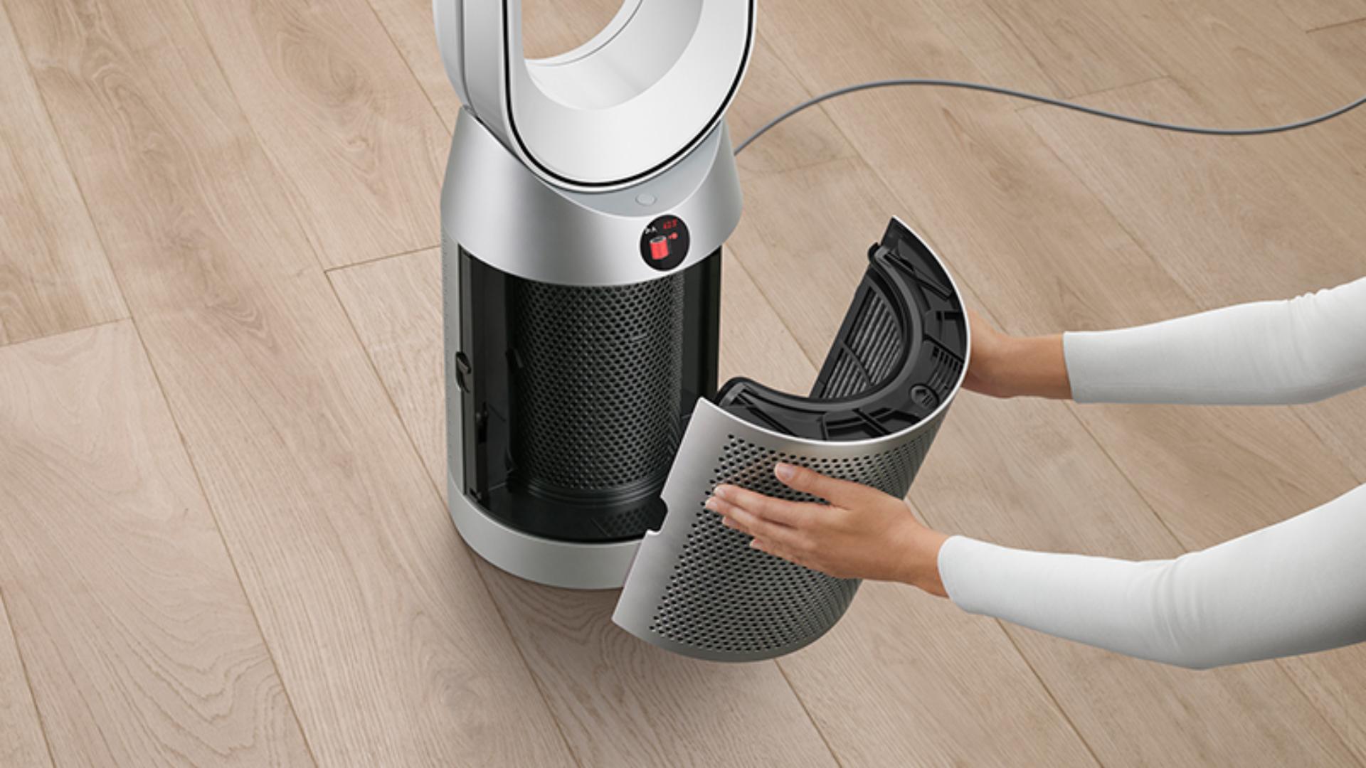 Someone changing a Dyson purifier's filter