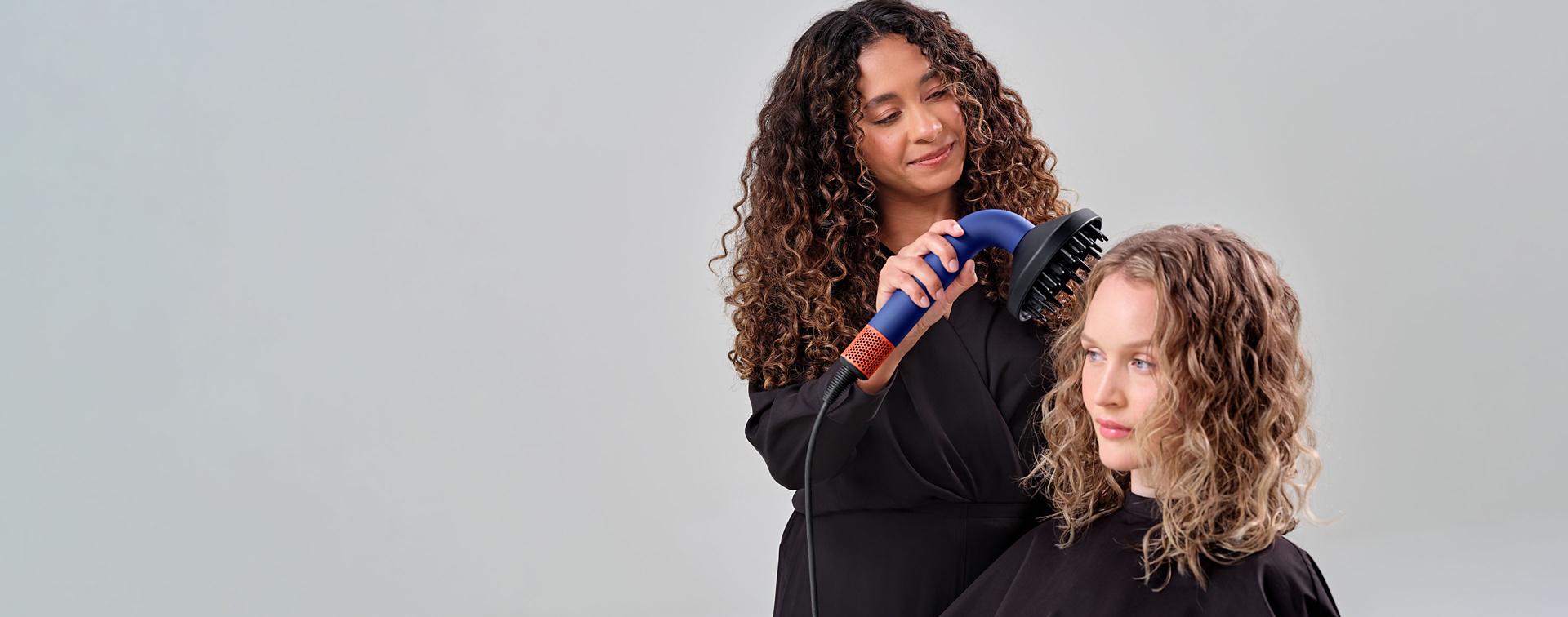 Irinel de Leon drying model's hair with Diffuser attachment on Dyson Supersonic r Professional hair dryer.