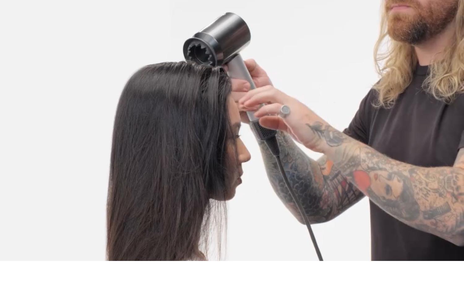 Professional stylist using the Dyson Supersonic professional dryer