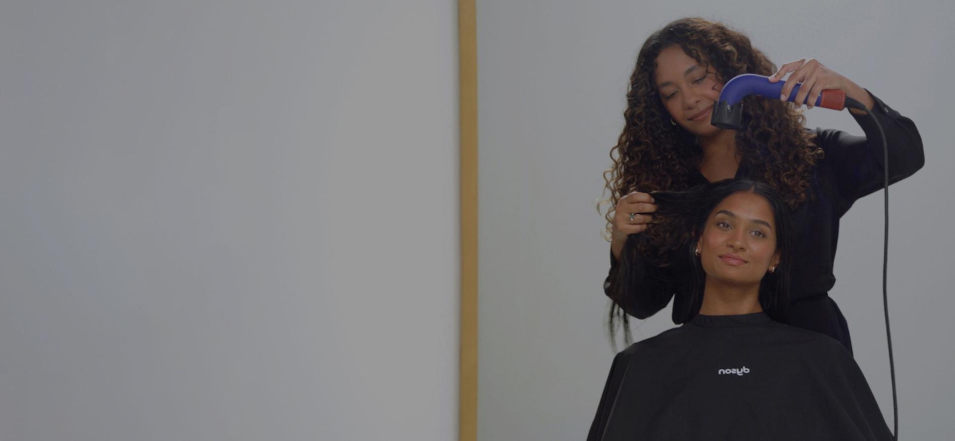 Dyson Supersonic r Professional hair dryer is used on a model to dry hair.