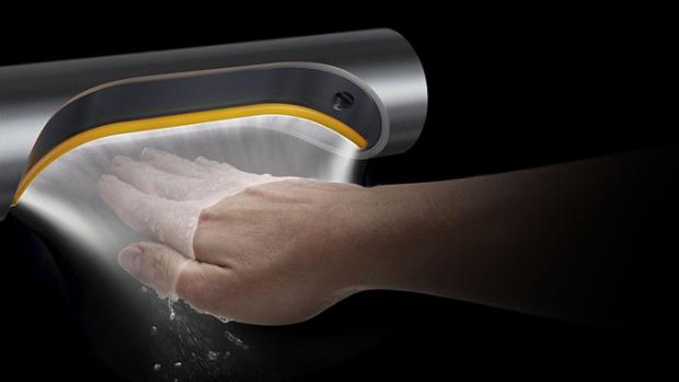 A hand held below a Dyson Airblade 9kJ hand dryer with an illustration to show how the air is propelled along the surface of the hand.