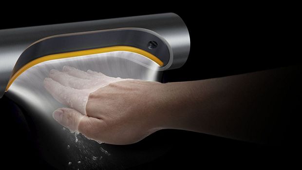 A hand held below a Dyson Airblade 9kJ hand dryer with an illustration to show how the air is propelled along the surface of the hand.