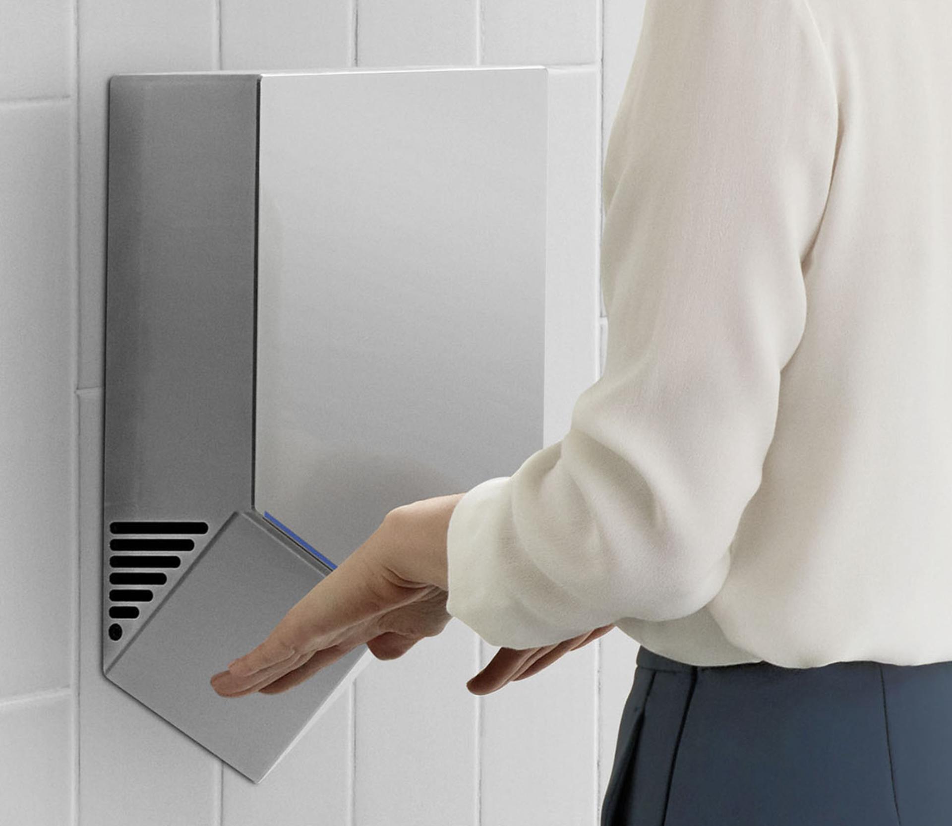 A pair of hands being dried below a Dyson Airblade V.