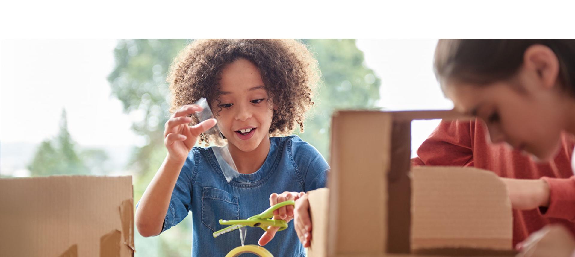 A child engages with an engineer challenge.