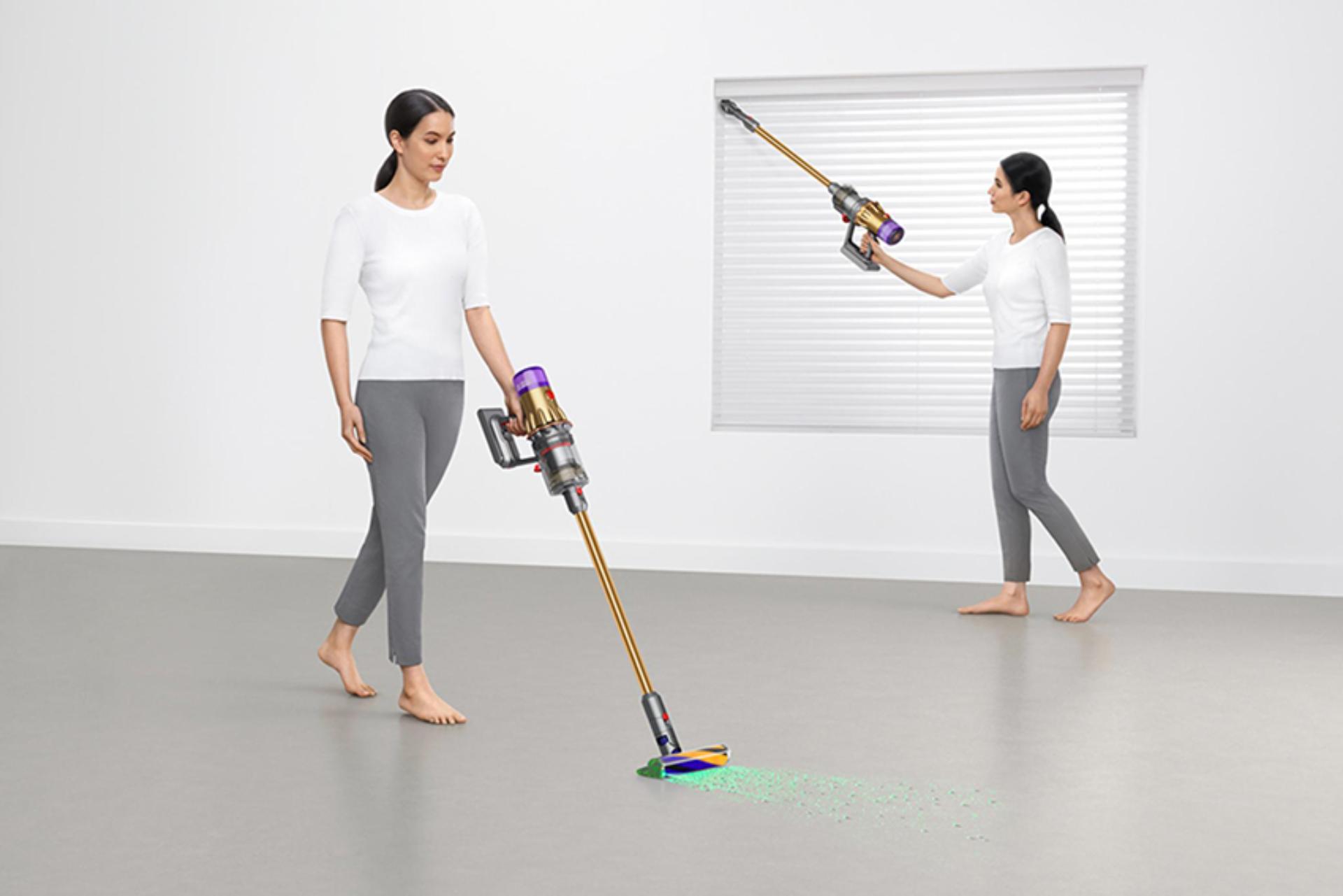 Women using Dyson vacuum to clean room