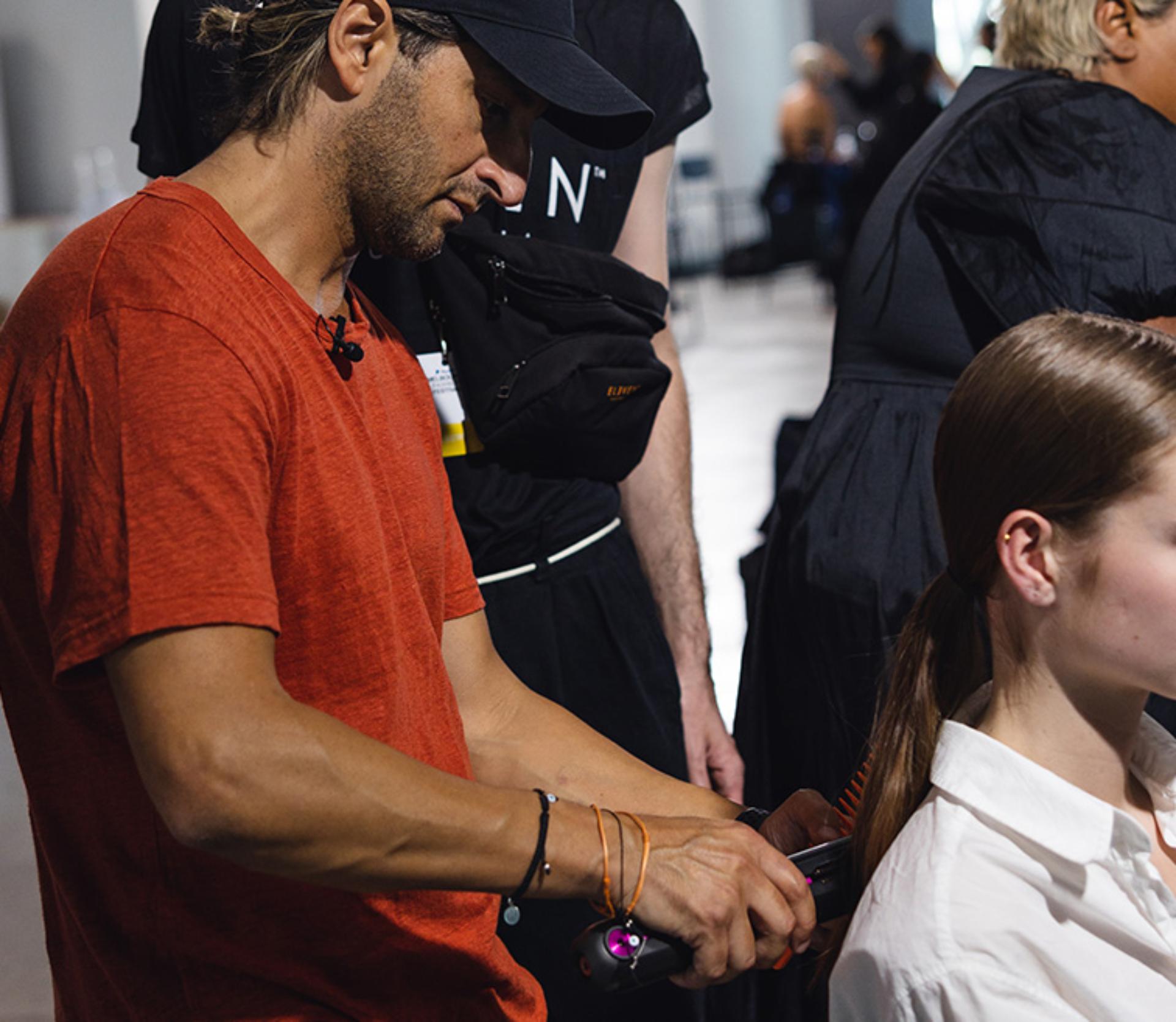 Joey styling models hair with Dyson Corrale straightener