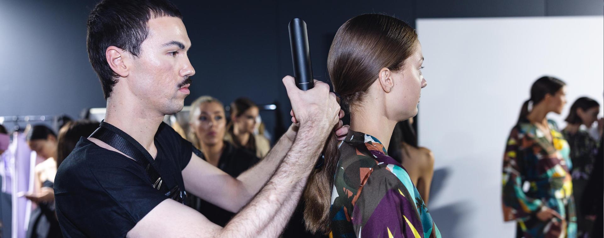 Models getting their hair styled by Dyson hair care technology