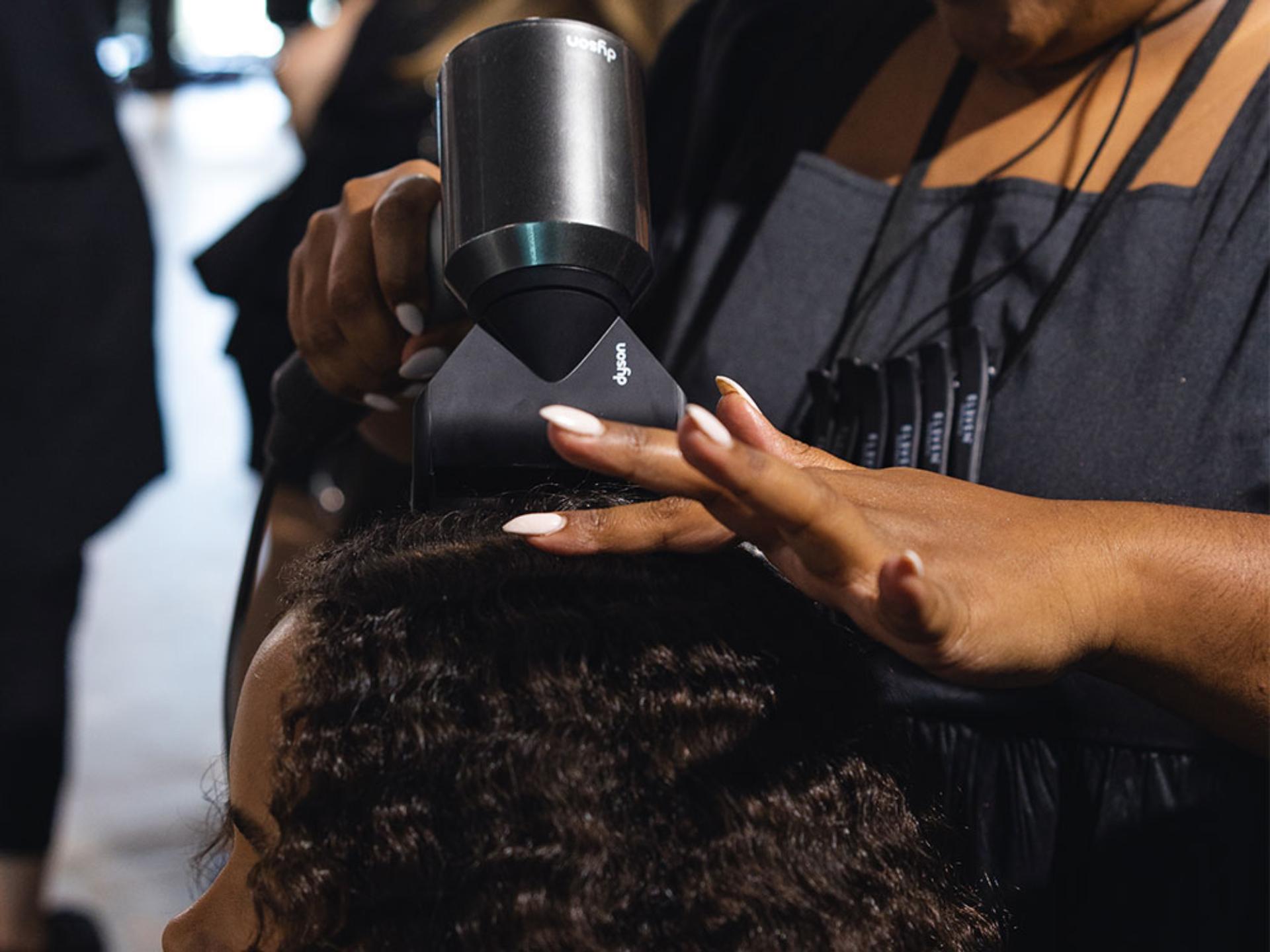 Dyson supersonic being used on models hair