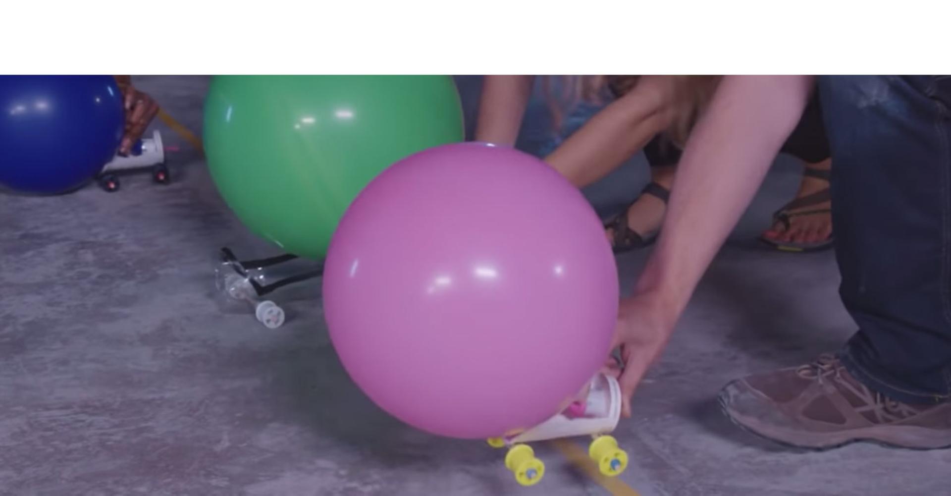 A Dyson engineer shows the balloon powered race car challenge.