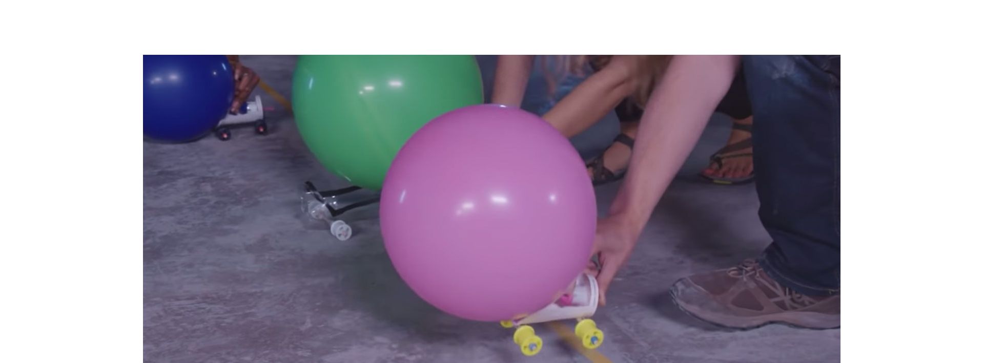 A Dyson engineer shows the balloon powered race car challenge.