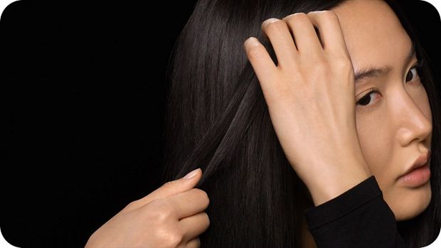 Model applies Post-style serum to her finished style