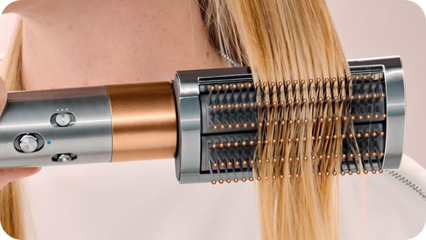 Model uses Dyson Airwrap multi-styler and dryer to curl and style hair