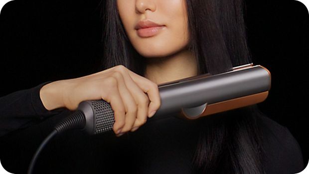 Model uses Dyson Airstrait wet to dry straightener to dry and style hair