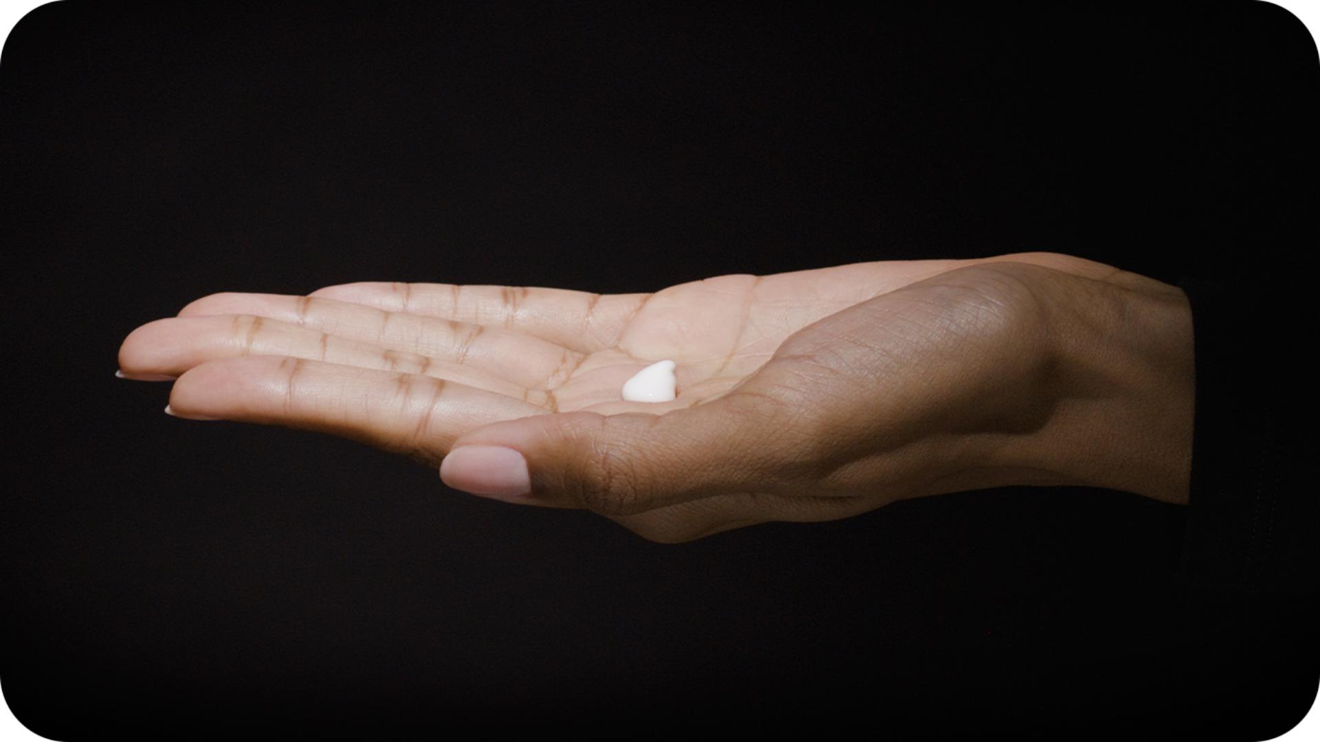 A model's hand demonstrating the Dyson Chitosan pump dispenser